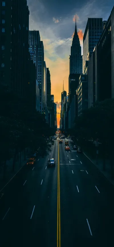 纽约黄昏街景：高楼林立的城市大道 · iPhone 16 Pro 4K 壁纸